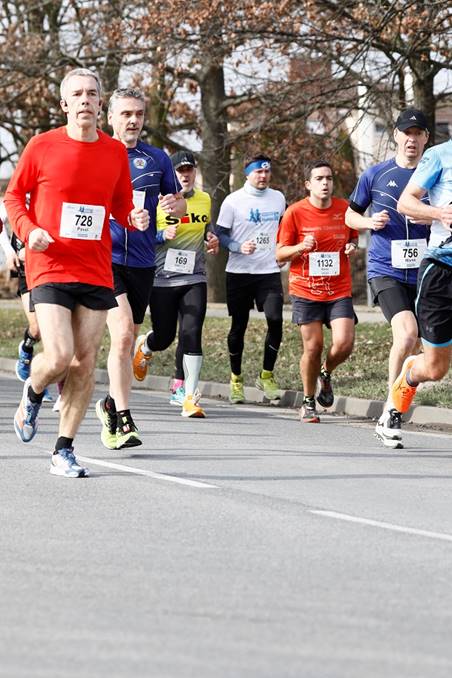 A group of people running on a road

Description automatically generated